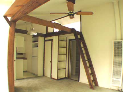Looking from the living room into kitchen, showing storage loft above